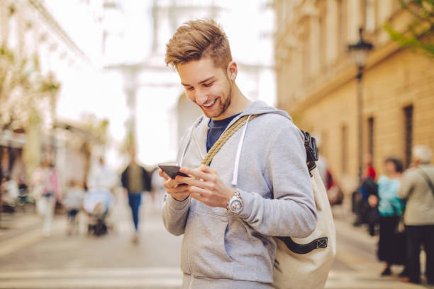 istock Young man using phone in the city 669638204