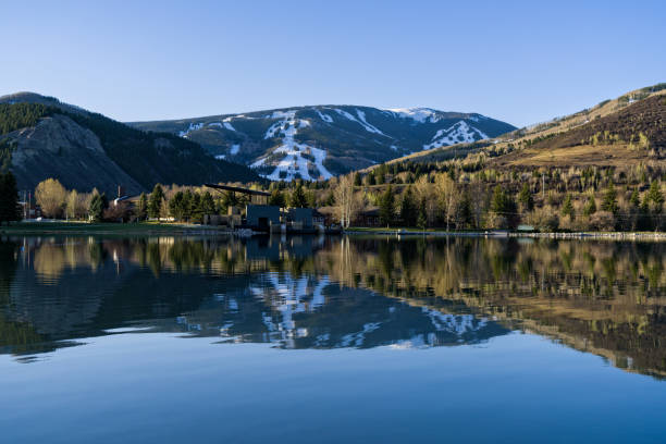 Beaver Creek Reflected in Nottingham Lake Avon Colorado - Scenic view with ski runs and snow reflected in lower valley lake where it's spring.