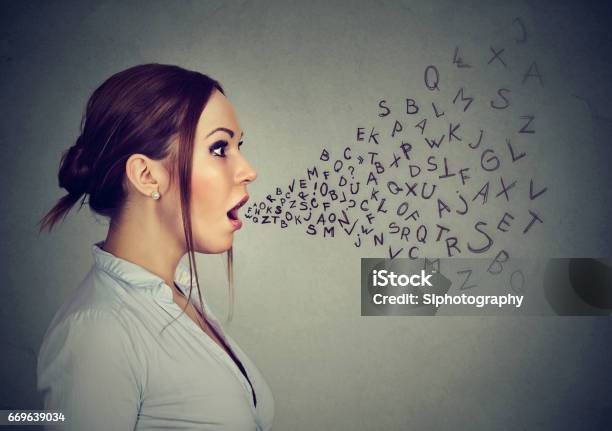 Woman Talking With Alphabet Letters Coming Out Of Her Mouth Stock Photo - Download Image Now