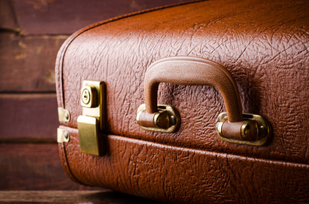 istock Old vintage, retro suitcase on dark background. Front view 669639194