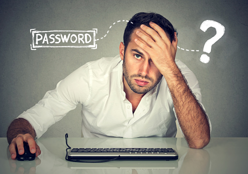 Desperate young man trying to log into his computer forgot password