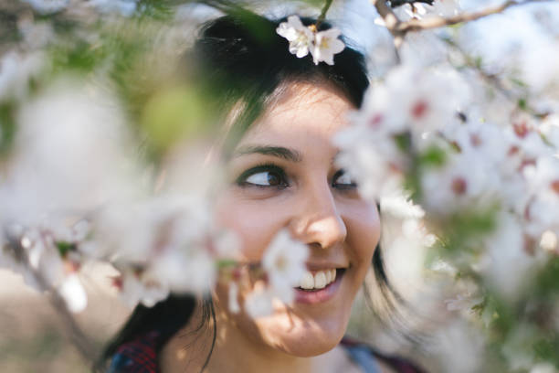 istock Young woman under almond-tree blossom 669645224