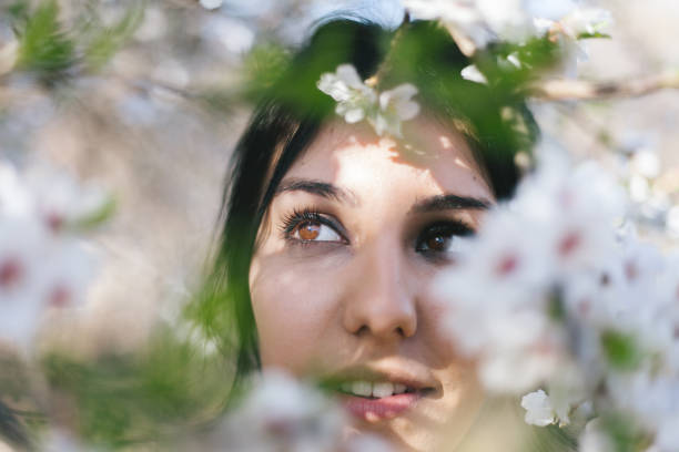 istock Young woman under almond-tree blossom 669645274