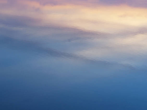 istock Abstract colorful background of sunrise sky reflection on water surface. 669645636