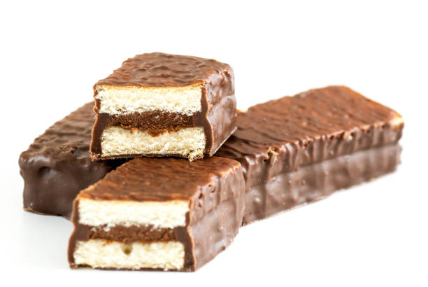 istock mini sponge cakes with cocoa cream and chocolate coating over white 669648166