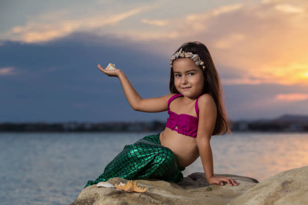 istock Girl on the beach at sunset 669649490