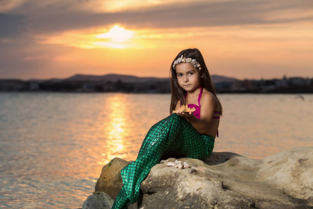 istock Girl on the beach and setting sun 669651794