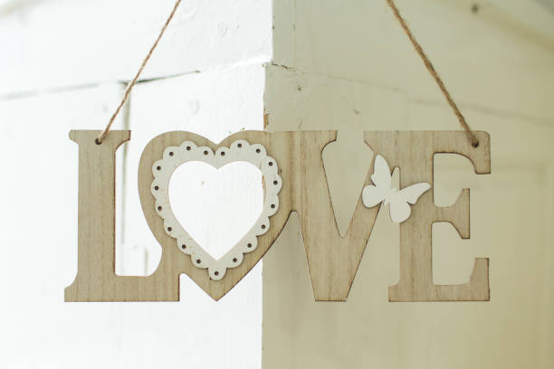 istock Wooden inscription love on the wall 669653414