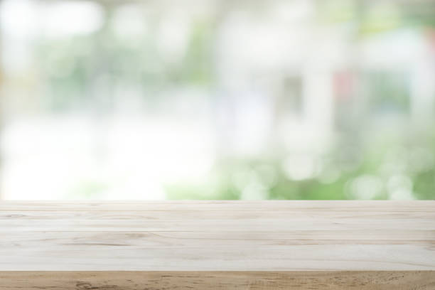 istock Wood table top on glass wall abstract background. 669667196