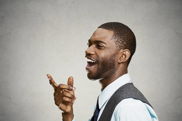 istock side view portrait, headshot young man, laughing, pointing with finger at someone, 669669652