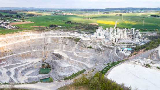 Aerial view of a large limestone quarry and industrial buildings