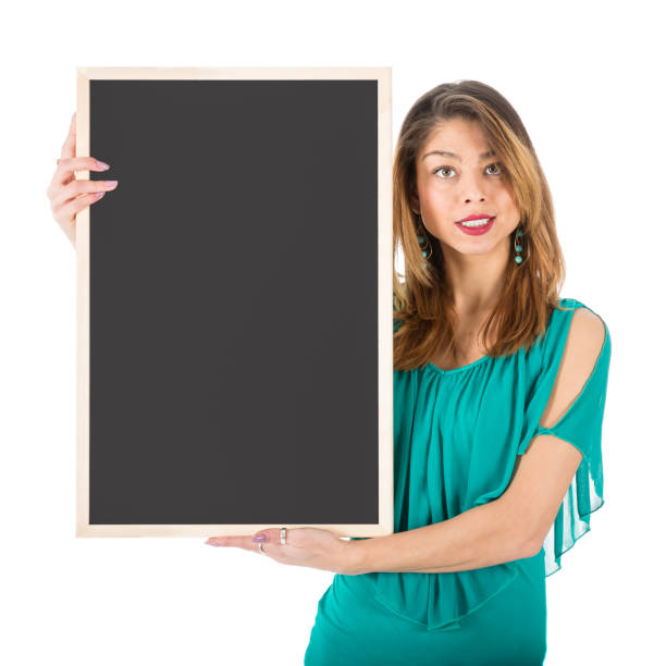 Beautiful woman holding empty chalkboard beside of her body Beautiful woman holding empty chalkboard beside of her body, isolated on white the human body writing black human hand stock pictures, royalty-free photos & images