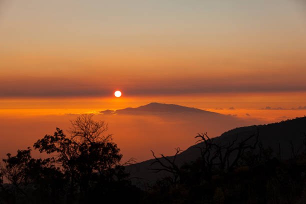 amazing sunset view from big islands mauna kea to mauis haleakala volcano mountain.