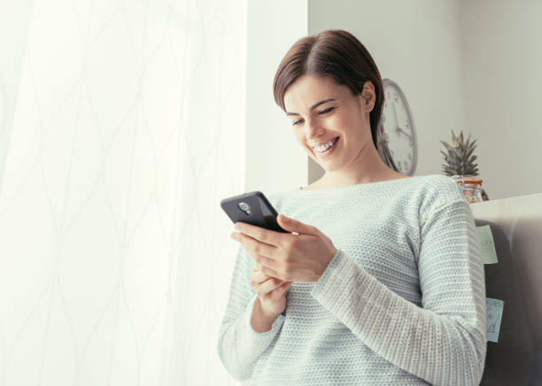 istock Woman texting in the kitchen 669680746