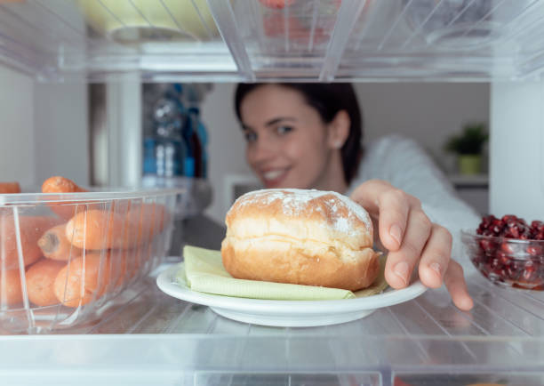 istock Woman having an unhealthy snack 669680782