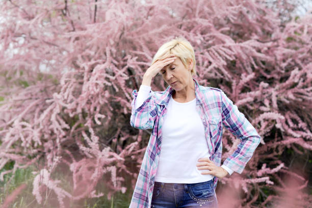 istock Vibrant blonde middle aged woman having a head ache-spring allergies 669680820