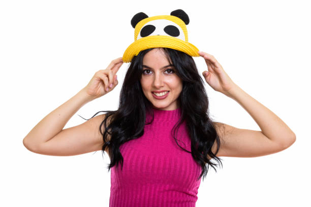 istock Studio shot of young happy Spanish woman smiling while holding hat with both hands 669681134