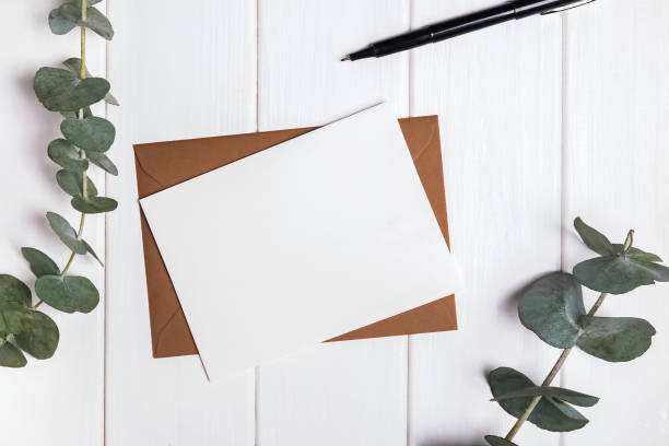 istock Paper card mock-up and eucalyptus branches on the white table 669684994