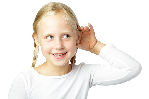 Child cupping ear - little girl listening, communication concept