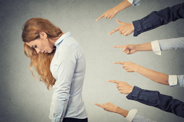 istock Side profile sad upset woman looking down many fingers pointing at her 669688442