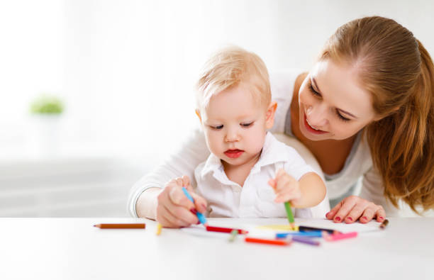 istock Mother with baby son with colored pencils 669694894
