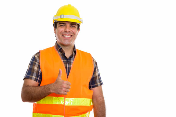 istock Studio shot of young happy Persian man construction worker smiling while giving thumb up 669695902