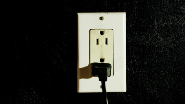 Timelapse: Fire in a dual-socket US type. Streams of black smoke come from the outlet. Danger to life and health
