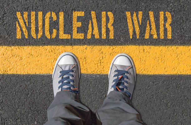 istock NUCLEAR WAR print with sneakers on asphalt road 669699284
