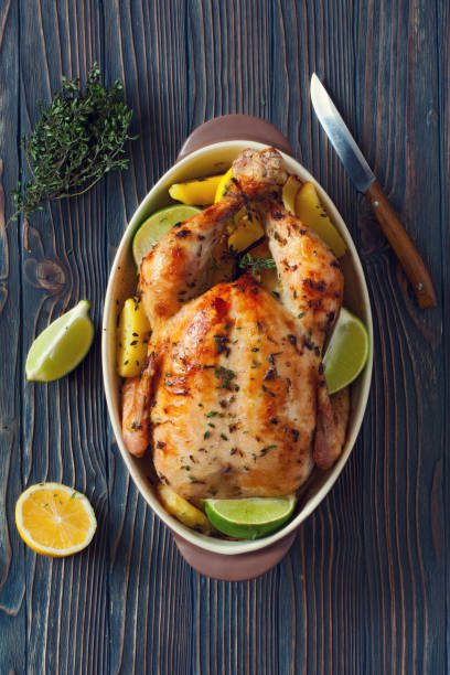 istock Fried whole chiken with potatoes and lemones 669699452