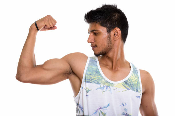 istock Profile view of young handsome Indian man flexing his arm 669701774