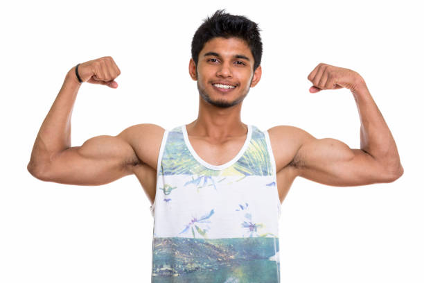 istock Studio shot of young happy Indian man smiling while flexing both arms 669701832