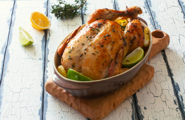 istock Fried whole chiken with potatoes and lemones 669702242