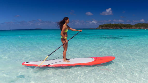 istock young attractive woman on paddleboard 669706074