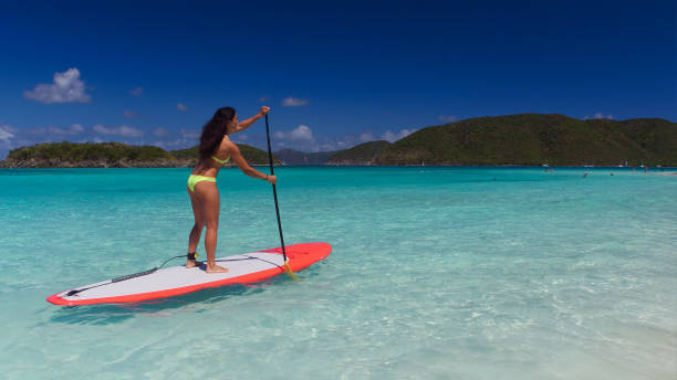 istock young attractive woman on paddleboard 669706090