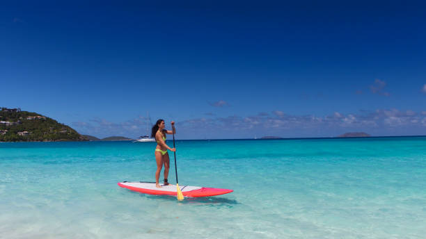 istock young attractive woman on paddleboard 669706104