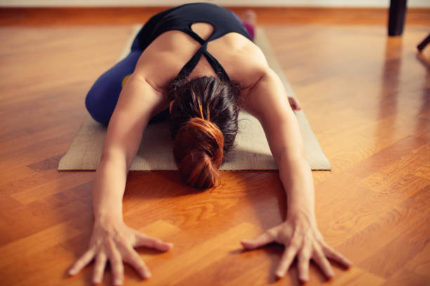 istock Woman doing yoga at home 669709250