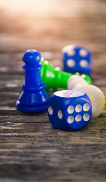 istock Dices and board game figure on wooden table 669712386
