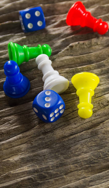 istock Dices and board game figure on wooden table 669712394