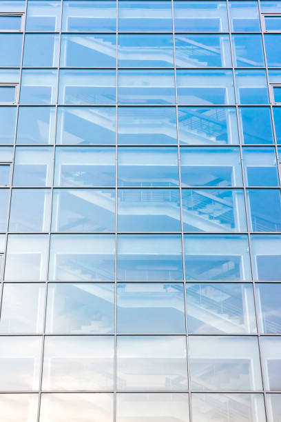 istock glass building exterior with staircase behind glass facade 669712748