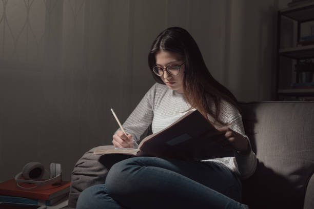 istock Girl studying late at night 669715492