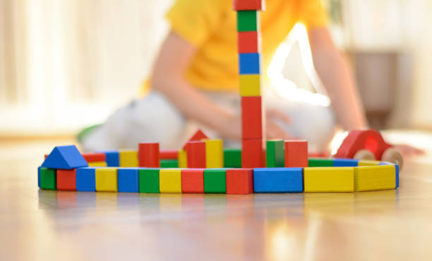 istock Beautiful little boy is playing with blocks 669715594