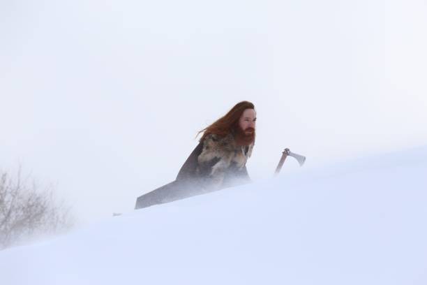 istock Medieval Winter Snow Viking Warrior, Authentic Costume, Animal Pelt, Axe 669716078