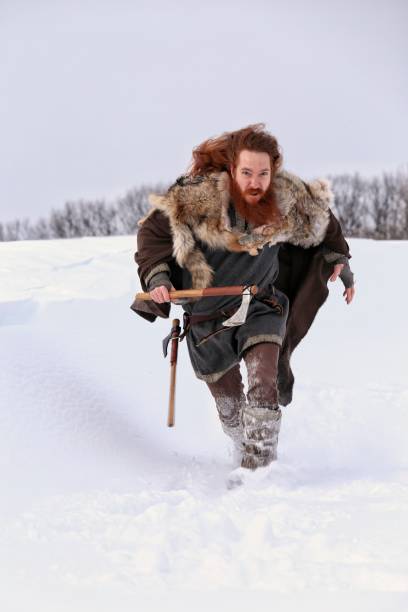 istock Medieval Winter Snow Viking Warrior, Authentic Costume, Animal Pelt, Ax 669718478