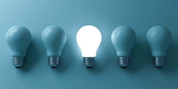 istock One glowing light bulb standing out from the unlit incandescent bulbs on green background with reflection and shadow , individuality and different business creative idea concepts . 3D rendering 669719478