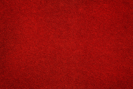 Red felt surface close up. Abstract texture and background