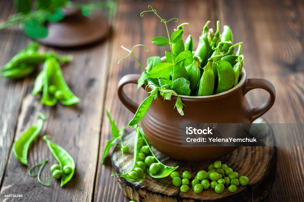 Fresh green peas on dark wooden rustic background Backgrounds Stock Photo