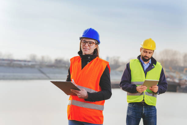 istock Teamwork in freight transportation industry - two engineers working together at the dock 669732798