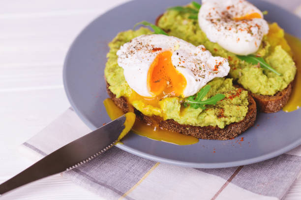 istock Toast with poached egg, puree avocado, spices and arugula 669733352