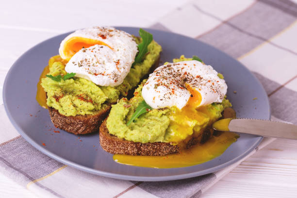 istock Toast with poached egg, puree avocado, spices and arugula 669733608