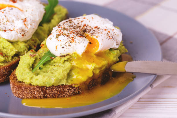istock Toast with poached egg, puree avocado, spices and arugula 669733656